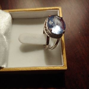 Silver color blue stone ring with clear crystals.